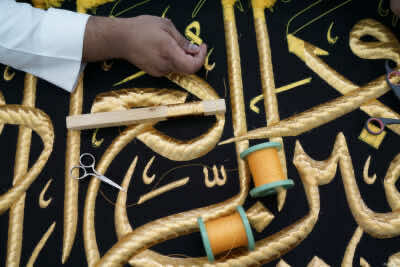 A man embroiders the Kiswa, a silk cloth covering the Holy Kaaba, ahead of the annual haj pilgrimage, at a factory in the holy city of Mecca