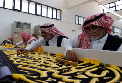 Men embroider the Kiswa, a silk cloth covering the Holy Kaaba, ahead of the annual haj pilgrimage, at a factory in the holy city of Mecca