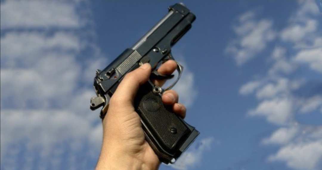 شرطي يشهر سلاحه